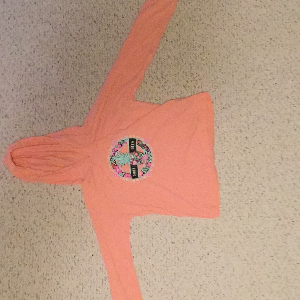 This is a kids T-shirt with a hood with it
